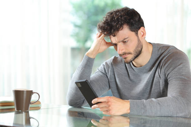 istock Worried man checking cell phone at home 2167367523