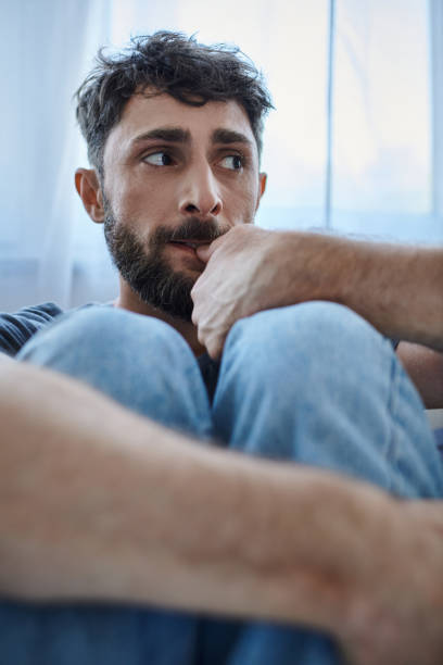istock A handsome man contemplates solitude and sadness in his cozy home during a quiet evening 2167368001