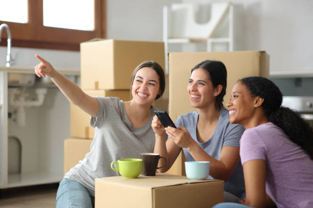 istock Three happy interracial roommates planning house reform 2167368095