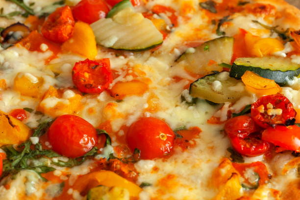 Pizza with vegetables and cheese on a wooden table