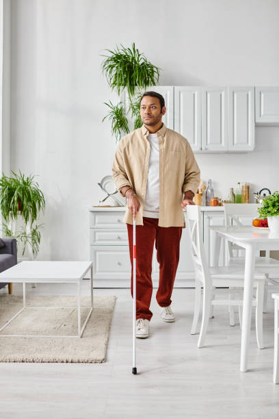istock Young man with vision impairment navigating a bright, stylish kitchen at home 2167368785