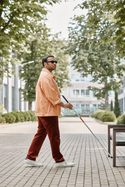 istock A young man with vision impairment navigating a city park on a sunny afternoon 2167368842
