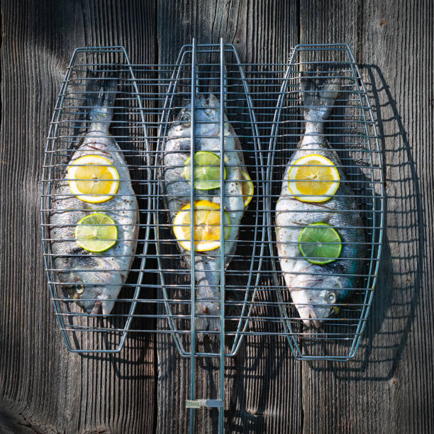 Prepared for grilling dorada fish on wood table. Food photography