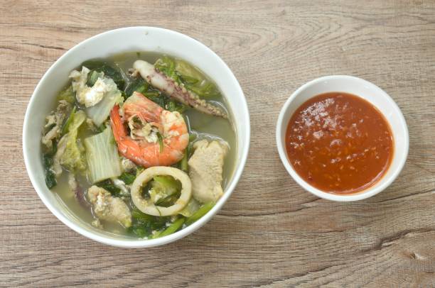 boiled sukiyaki seafood chicken and pork meat couple crispy pickled squid and shrimp with vegetable in soup dipping sauce