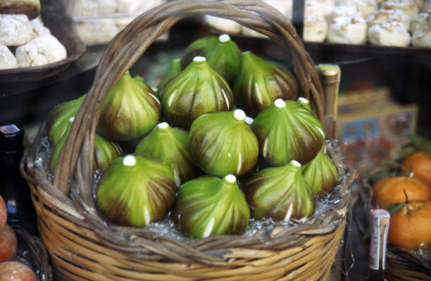 moldy overripe and spoiled figs with red flesh and seeds on a table, moldy spoiled figs with lots of grains and red spoiled flesh on a wooden table