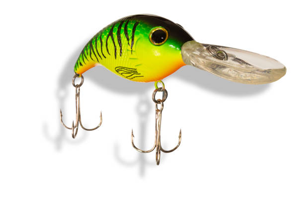 Shadow under an Artificial fishing lure that is cast out and reeled in with a pair of treble hooks.