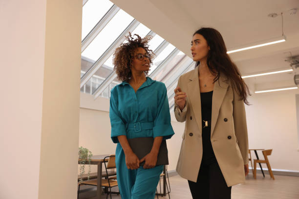 istock Two businesswomen walking in modern office 2167381497