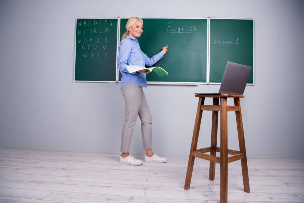 Photo of charming clever qualified woman school teacher work with pupils remotely explain material Photo of charming clever qualified woman school teacher work with pupils remotely explain material. qualified report stock pictures, royalty-free photos & images