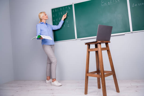 Photo of charming pretty clever qualified woman school college teacher work with children remotely explain material Photo of charming pretty clever qualified woman school college teacher work with children remotely explain material. qualified report stock pictures, royalty-free photos & images