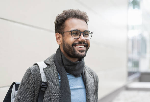 istock Handsome young man wearing warm clothing looking up 2167385833