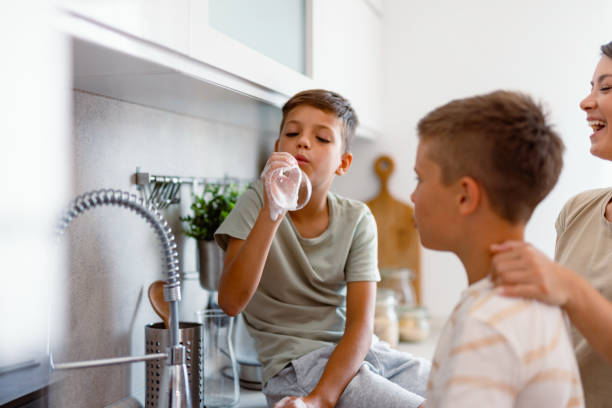 istock Boy blowing bubbles with dish soap, mom laughing 2167387109