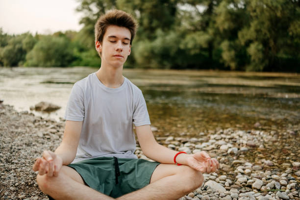 istock Boy exercising Yoga in Lotus position 2167387152
