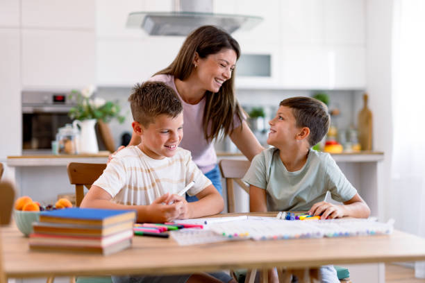 istock Mother and sons happy while doing homework together 2167387155