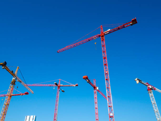 istock Many construction cranes standing still, close-up view at BudaPart construction site in twilight near to MOL Campus building, Kopaszi-gát. 2167387358