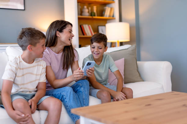 istock Family enjoys quality time on couch with shared laughter. 2167388000