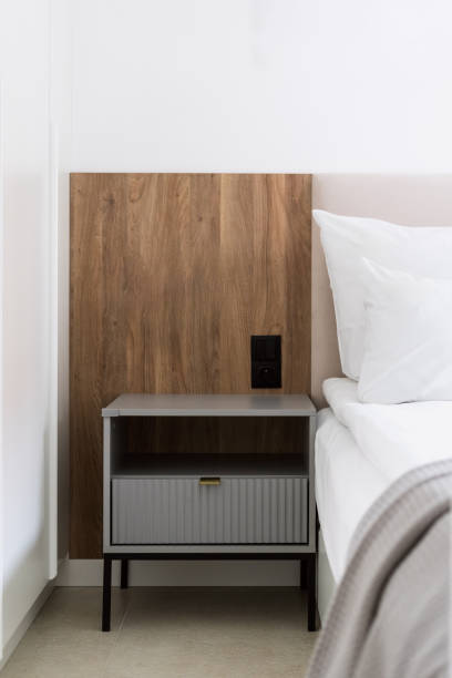 Modern bedroom corner with a bedside table and minimalist decor in bright natural light