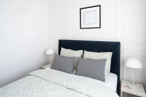 istock Cozy bedroom with modern decor featuring a blue headboard and stylish bedding 2167388666