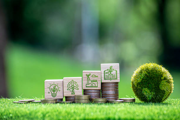 istock Carbon credit and CO2 emission reduction concept. Wooden cubes with CO2 icon on stack of silver coins and green globe with world map. Tax credits for enterprises to stop global warming process. 2167389230