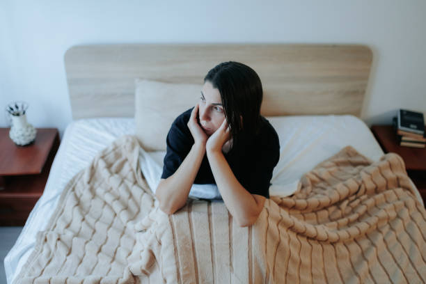 istock Sad Woman Sitting Alone on Bed, Coping with Nighttime Depression 2167390000