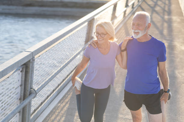 istock Man and woman stretching legs on a bridge during morning exercise 2167395029