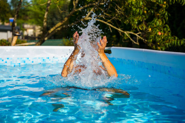 istock A man in the pool splashes with water 2167396016