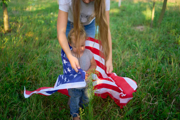 toddler with american flag on independence day picnic