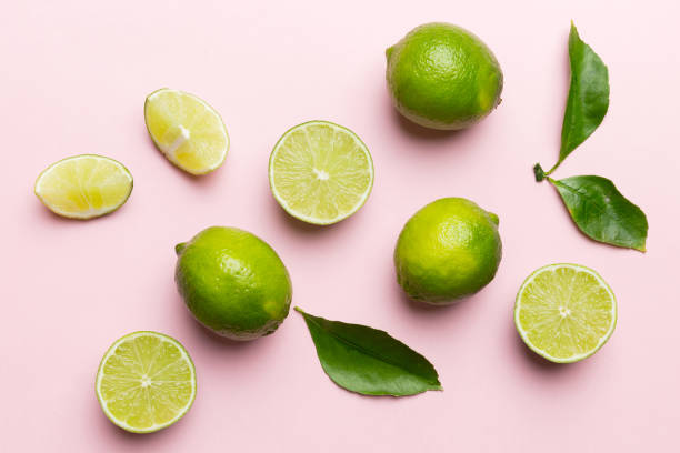 istock Lime fruits with green leaf and cut in half slice isolated on white background. Top view. Flat lay with copy space 2167403887