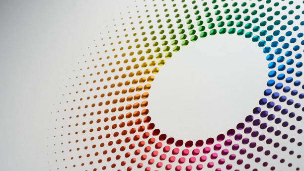 istock Vibrant radial pattern of multicolored paper dots arranged in a circular formation against a white background. 2167404084
