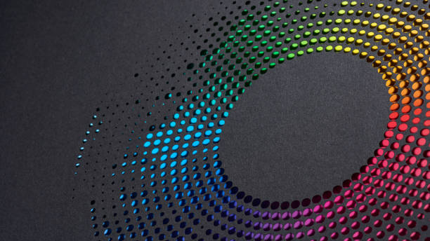 istock Dynamic and colorful circular pattern of cut paper dots arranged on a sleek dark background surface. 2167404161