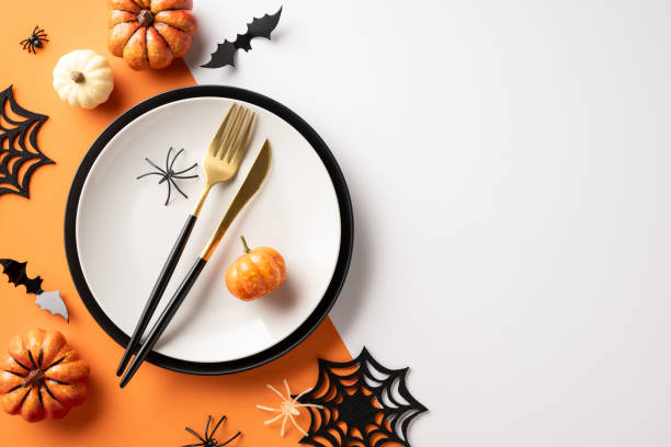 istock Halloween themed table setting featuring pumpkins, spider decorations, black cutlery, and a festive plate layout 2167406207