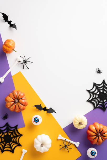 istock Creative vertical Halloween theme featuring pumpkins, bats, spiders, and web decorations on a vibrant orange and purple background. Ideal for seasonal celebrations and spooky presentations 2167406227