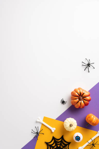 istock Creative vertical Halloween trick or treat background featuring decorative pumpkins, spiders, and spooky elements on a colorful surface 2167406229