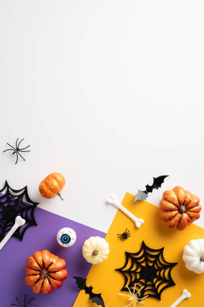 istock Creative vertical Halloween decorations with pumpkins, bats, spider webs, bones on vibrant purple and orange backgrounds. Perfect for Halloween celebrations, trick or treat themes, and holiday designs 2167406230