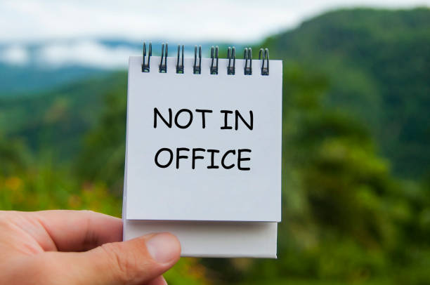 istock Not in office text on white notepad with nature background. Out of office concept 2167407410