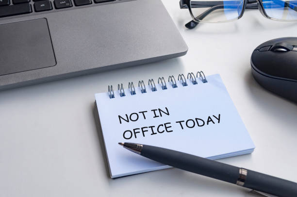 istock Not in office today text on with notepad with office background. Out of office concept 2167407439