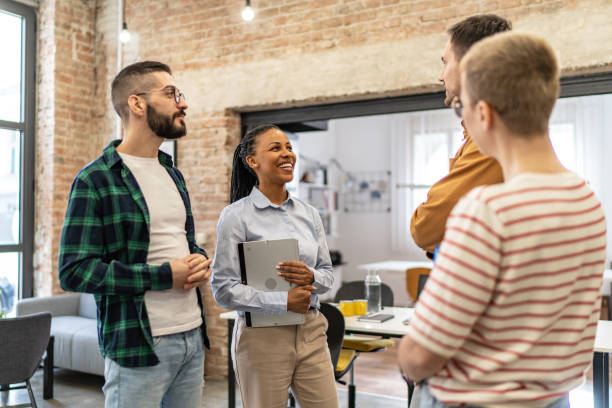 istock Young diverse colleagues, standing in the office and having a conversation 2167408531
