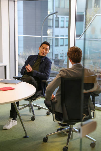 istock Businessmen talking in office 2167411080