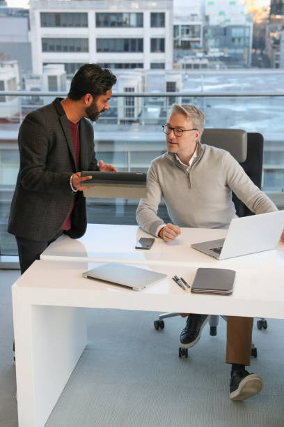 istock Businessmen talking in office 2167411120