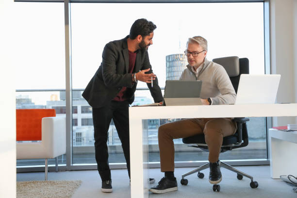 istock Businessmen talking in office 2167411145