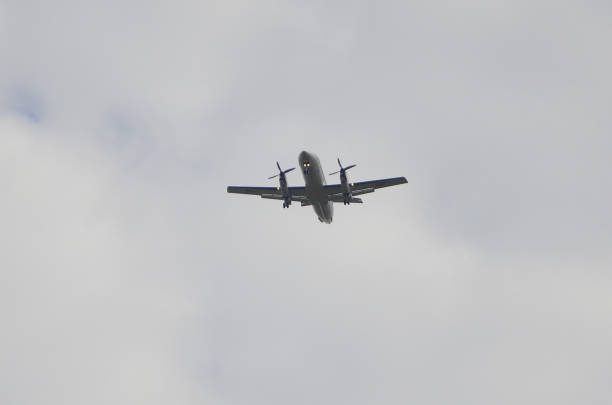 istock In the sky a plane with headlights on flying 2167412112