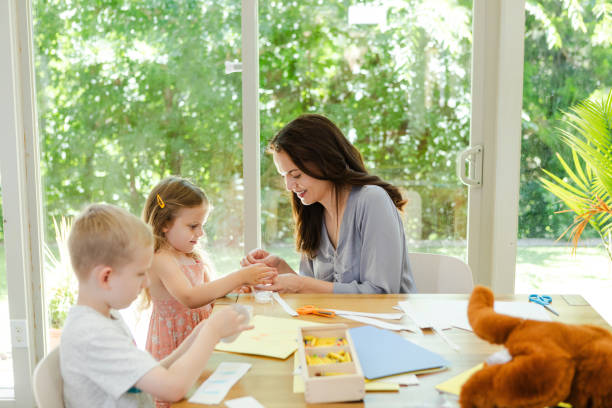 istock Single mother spends time with her kids at the dining room table 2167412229