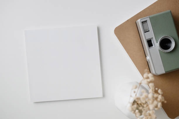 istock White blank greeting or invitation card with ceramic jar decoration and envelope on beige background. Mock up presentation. Flat lay. 2167413004