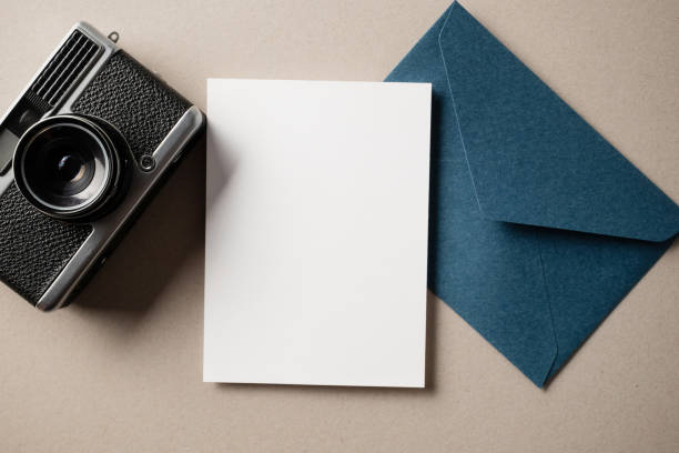 istock White blank greeting or invitation card and envelope on beige background. Mockup presentation. Flat lay. 2167413121