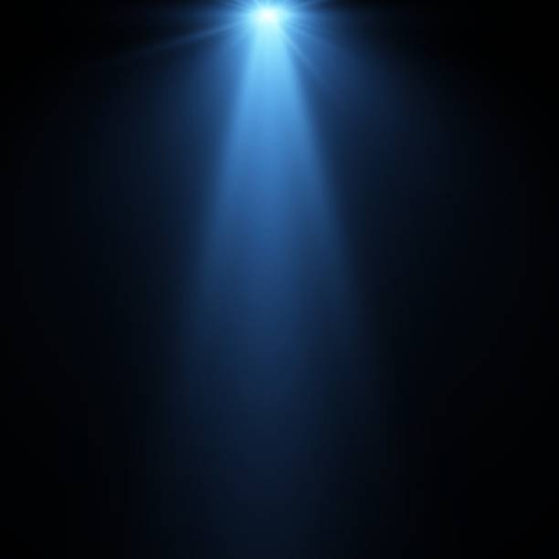 Studio light rays on blue background.Light effect blue glowing light. Solar flare. Glow effect. Starburst with shimmering sparkles Studio light rays on blue background.Light effect blue glowing light. Solar flare. Glow effect. Starburst with shimmering sparkles spotlight stock illustrations