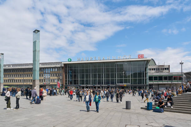 Travelers on the station forecourt of Cologne Central Station stock photo