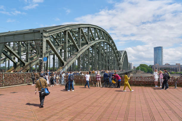 Cologne, Germany – May 25, 2024: Tourists from all over the world at the Hohenzollern Bridge in Cologne with its many love locks