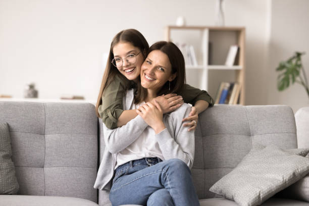 istock Caring teenage daughter hugging mom from behind 2167431123