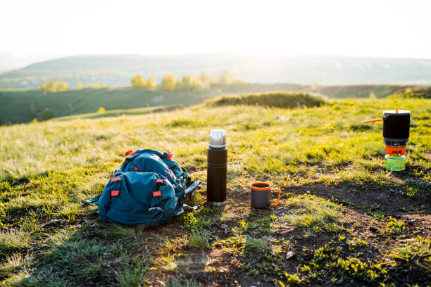istock Backpack resting on grassy field under blue sky in natural landscape 2167432457