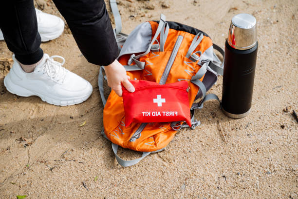 istock Getting ready for a hiking trip on the beach with essential gear backpack, first aid kit, thermos, and hiking boots. Ensuring safety and preparedness for outdoor adventure 2167432475
