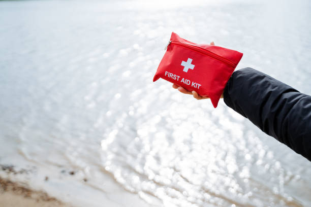 istock A beachgoer is carrying a red first aid kit by the water 2167432492
